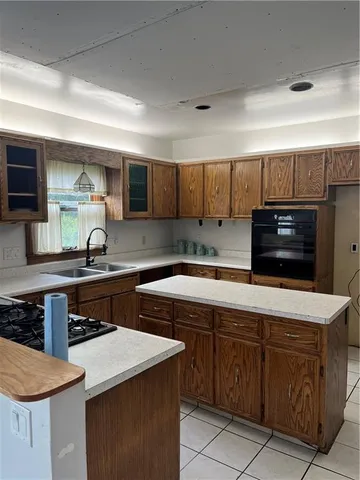 a kitchen with stainless steel appliances a stove sink and cabinets