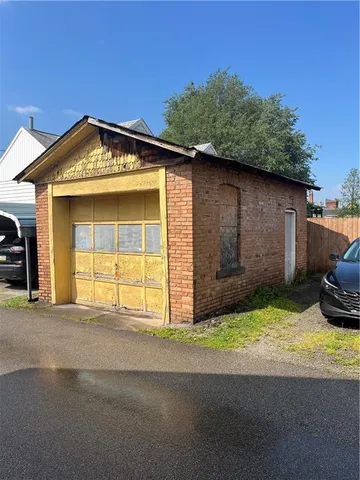 a view of a house with a yard and garage