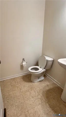 a white toilet sitting next to a shower