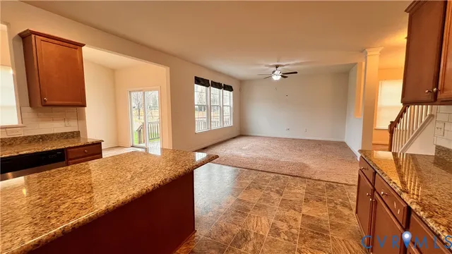 a spacious bedroom with a granite countertop sink and a mirror