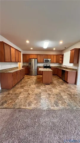 a kitchen with a refrigerator and a sink