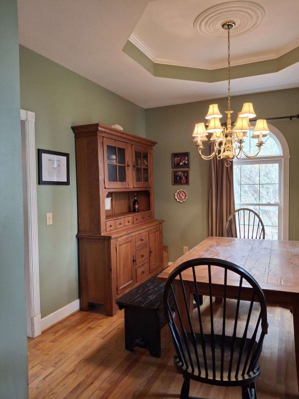 1525 Harkreader Road Mount Juliet, TN 37122 - Photo 5 of 20 a dining room with furniture a chandelier and wooden floor