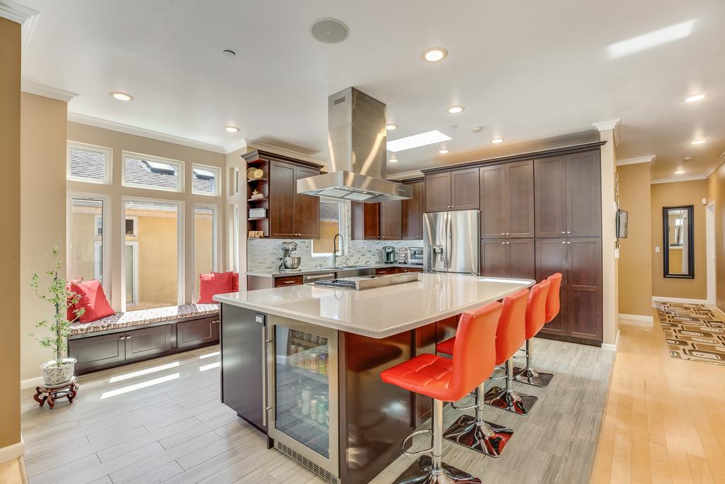 641 Hickey Boulevard Pacifica, CA 94044 - Photo 11 of 32 a large kitchen with stainless steel appliances kitchen island granite countertop a sink and cabinets