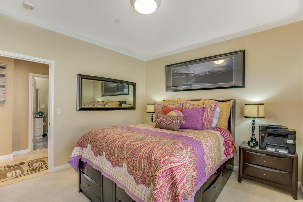 641 Hickey Boulevard Pacifica, CA 94044 - Photo 13 of 32 a bedroom with a bed and a painting on the wall