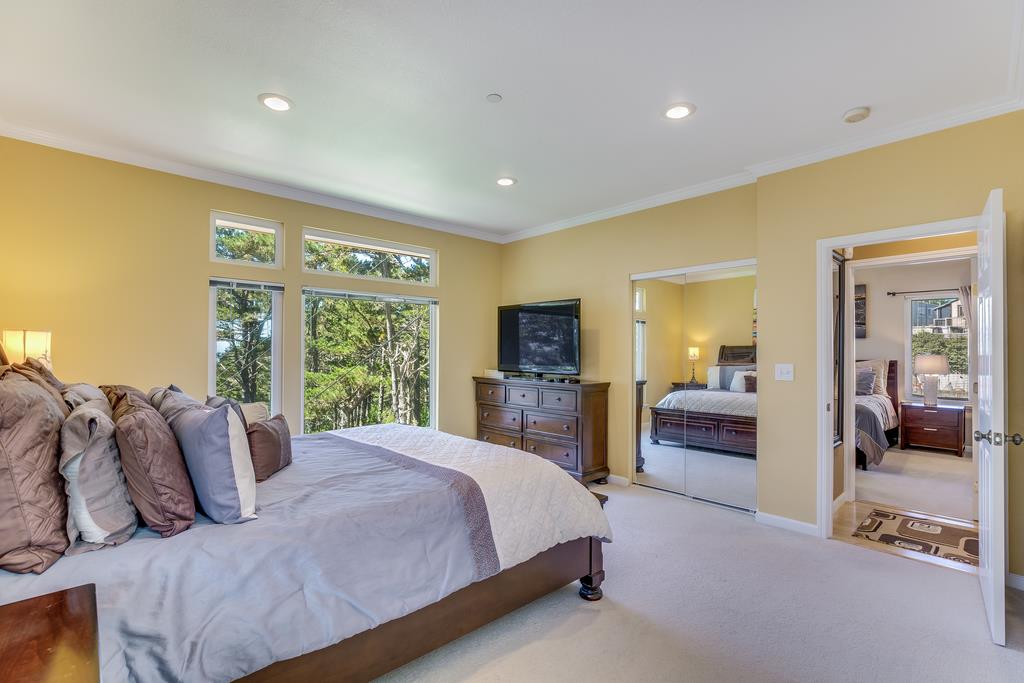 641 Hickey Boulevard Pacifica, CA 94044 - Photo 17 of 32 a bedroom with a large bed and a large window