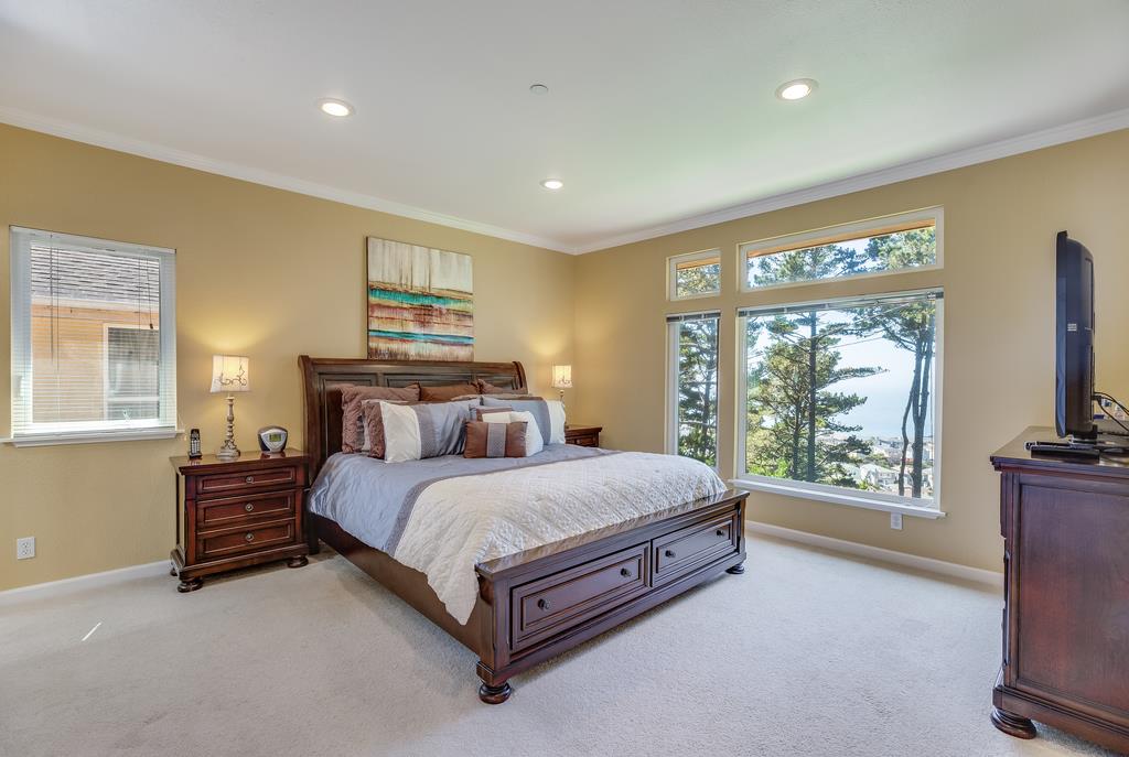 641 Hickey Boulevard Pacifica, CA 94044 - Photo 18 of 32 a bed sitting in a spacious bedroom next to a window