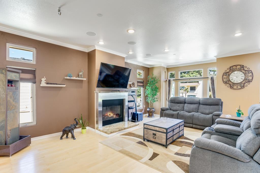 641 Hickey Boulevard Pacifica, CA 94044 - Photo 3 of 32 a living room with furniture a flat screen tv and a fireplace