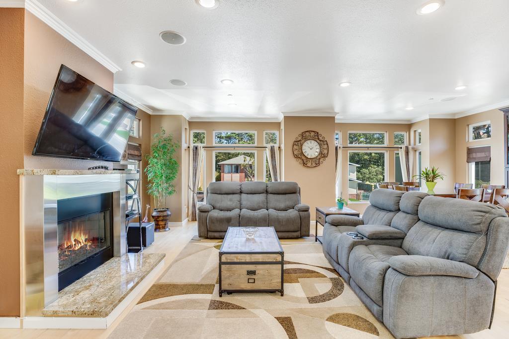 641 Hickey Boulevard Pacifica, CA 94044 - Photo 5 of 32 a living room with furniture a flat screen tv and a fireplace
