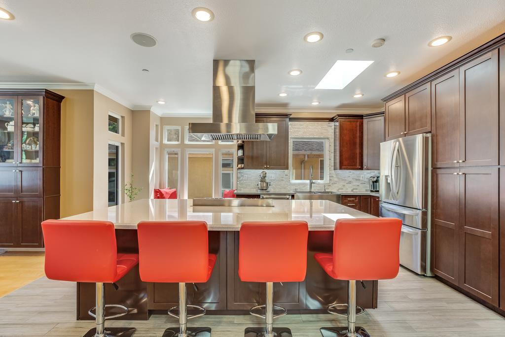 641 Hickey Boulevard Pacifica, CA 94044 - Photo 10 of 32 a kitchen with stainless steel appliances kitchen island granite countertop a dining table chairs and refrigerator