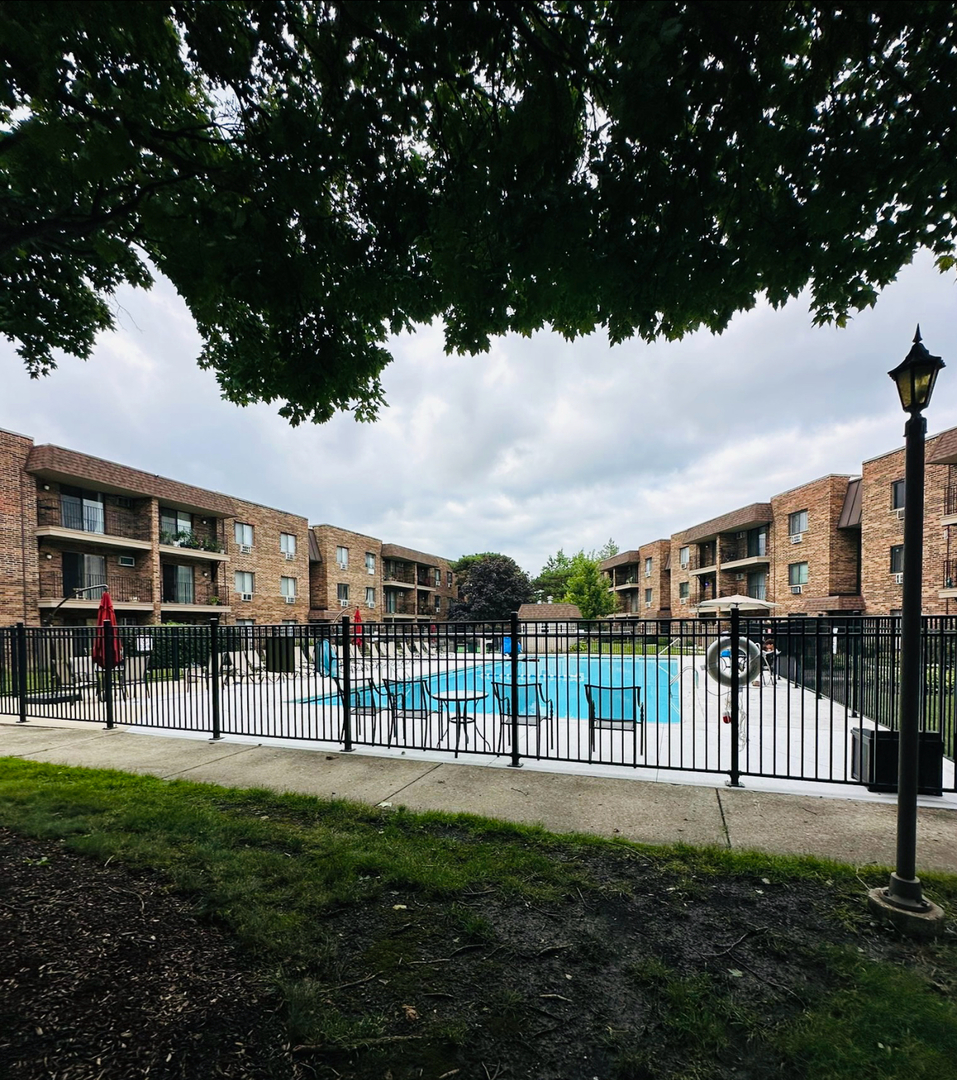 3515 Central Road, Unit 103 Glenview, IL 60025 - Photo 22 of 27 a view of a yard with a wooden fence