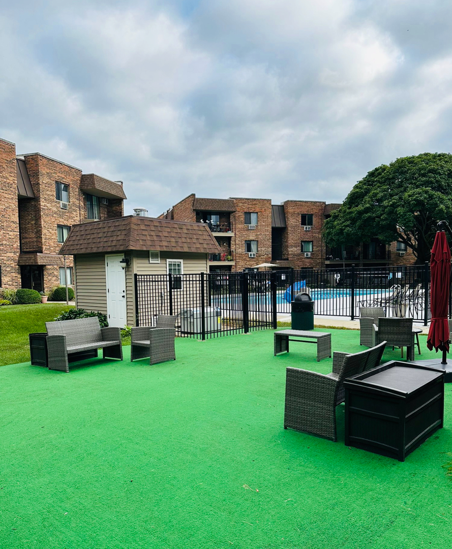 3515 Central Road, Unit 103 Glenview, IL 60025 - Photo 23 of 27 a view of a house with a big yard and sitting area
