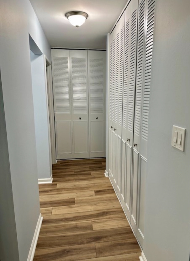 3515 Central Road, Unit 103 Glenview, IL 60025 - Photo 10 of 27 a view of a hallway with wooden floor and staircase