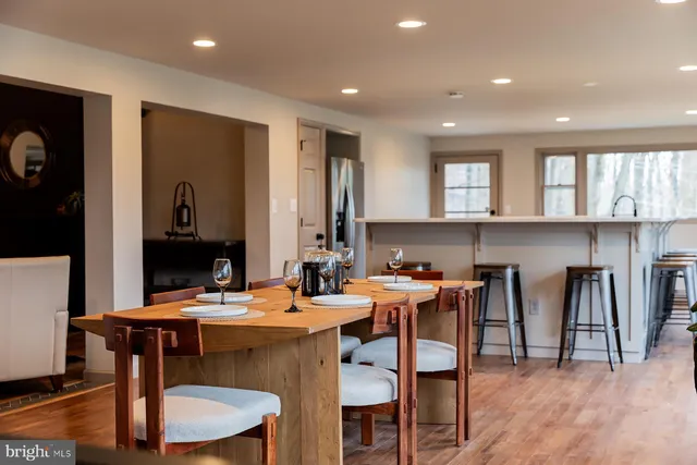 a bedroom with a large bed and wooden floor