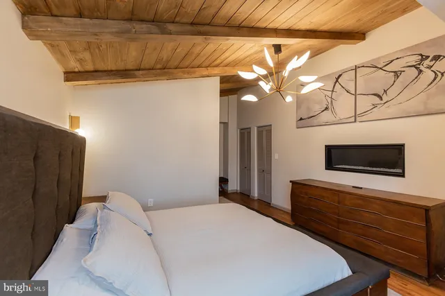 a bedroom with a large bed and a window