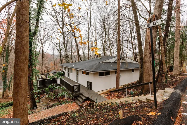 a view of a balcony with wooden floor and fence