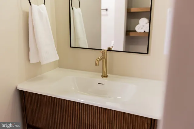 a view of a dining room and livingroom with furniture wooden floor a rug and a chandelier