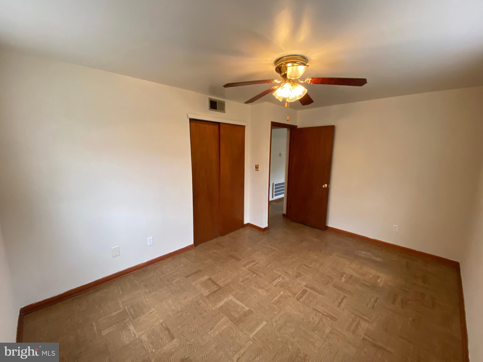 423 Hill Street, Unit 2 Culpeper, VA 22701 - Photo 10 of 18 an empty room with closet and a chandelier fan