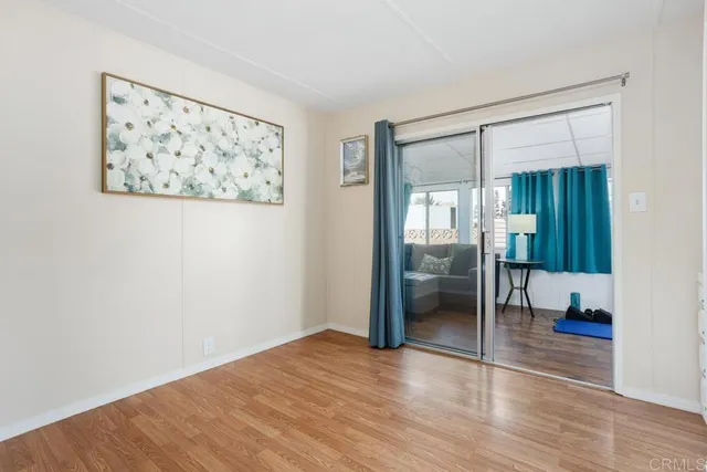 a view of a big room with wooden floor and a bedroom