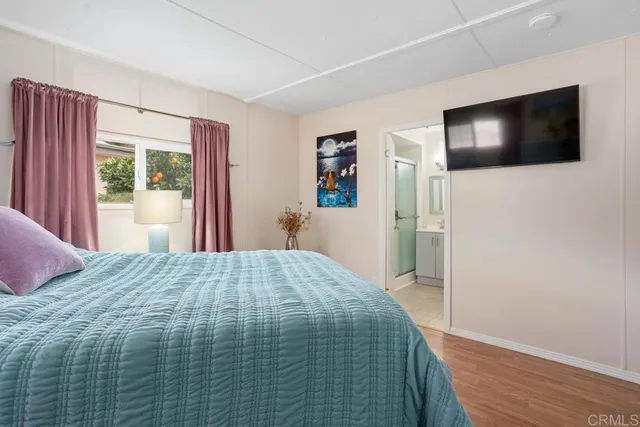 a bedroom with a bed and a flat screen tv