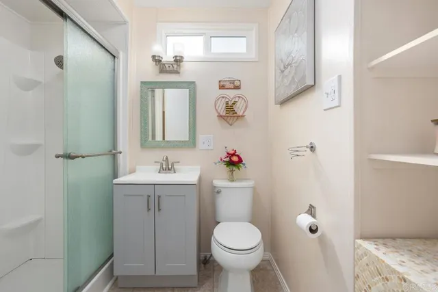 a bathroom with a sink toilet and shower