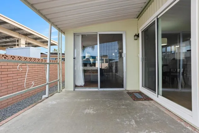 a view of a porch with wooden floor and a backyard space