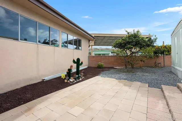 a view of a street with potted plants