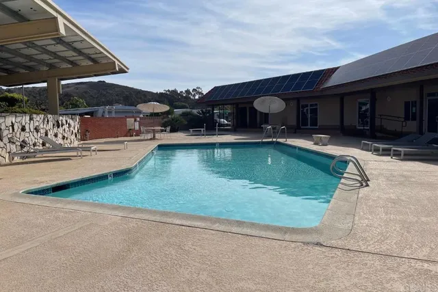 a view of a swimming pool with sitting area