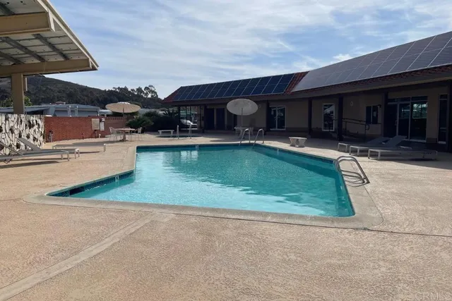 a view of a swimming pool with a table and chairs