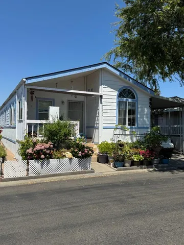 front view of a house with a bench in a yard