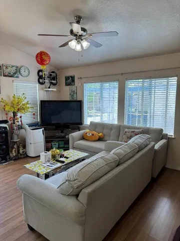 a living room with furniture fireplace and flat screen tv