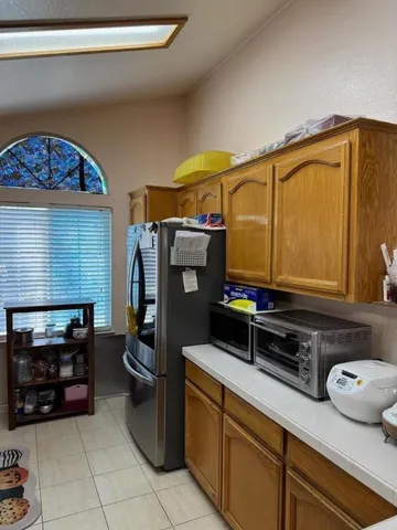 a kitchen with a refrigerator and a stove