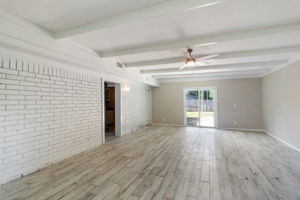 4104 Marsh Street Bryan, TX 77803 - Photo 12 of 26 a view of an empty room with wooden floor and a window