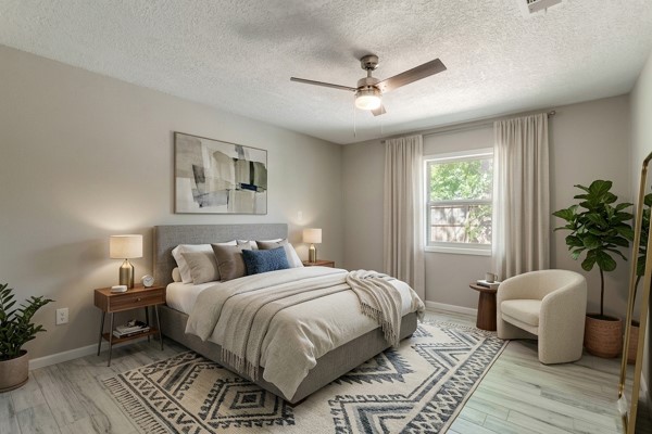 4104 Marsh Street Bryan, TX 77803 - Photo 13 of 26 a bedroom with a large bed a potted plant and a window