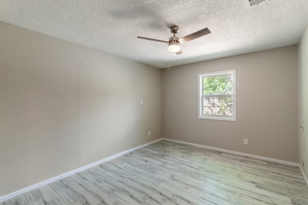 4104 Marsh Street Bryan, TX 77803 - Photo 14 of 26 wooden floor in an empty room with a window