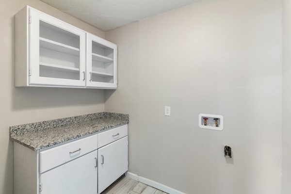 4104 Marsh Street Bryan, TX 77803 - Photo 24 of 26 a utility room with granite countertop cabinets washer and dryer