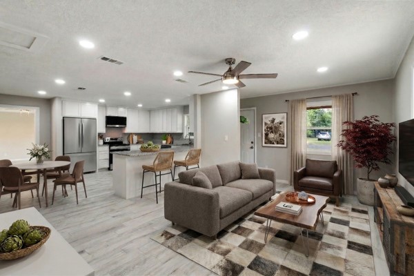4104 Marsh Street Bryan, TX 77803 - Photo 6 of 26 a living room with furniture kitchen view and a wooden floor