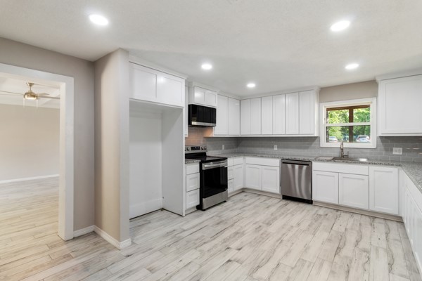 4104 Marsh Street Bryan, TX 77803 - Photo 9 of 26 a kitchen with granite countertop a stove top oven sink and cabinets