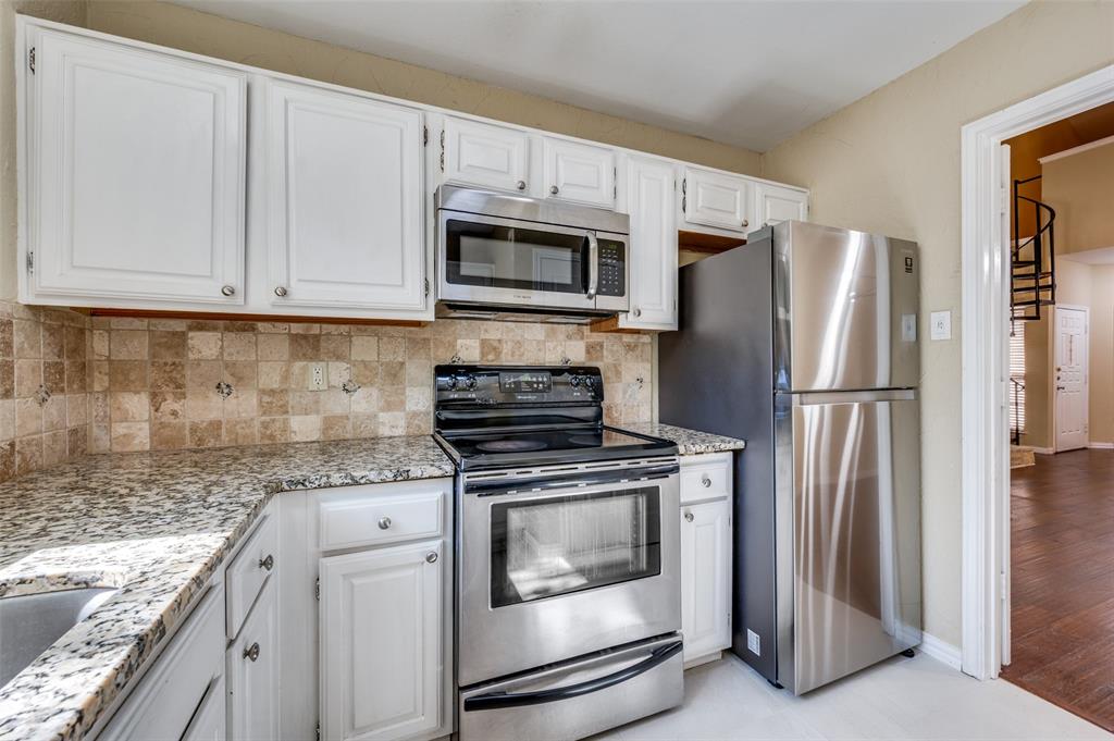 5565 Preston Oaks Road, Unit 130 Dallas, TX 75254 - Photo 11 of 25 Kitchen featuring stainless steel appliances, white cabinetry, backsplash, and light stone countertops
