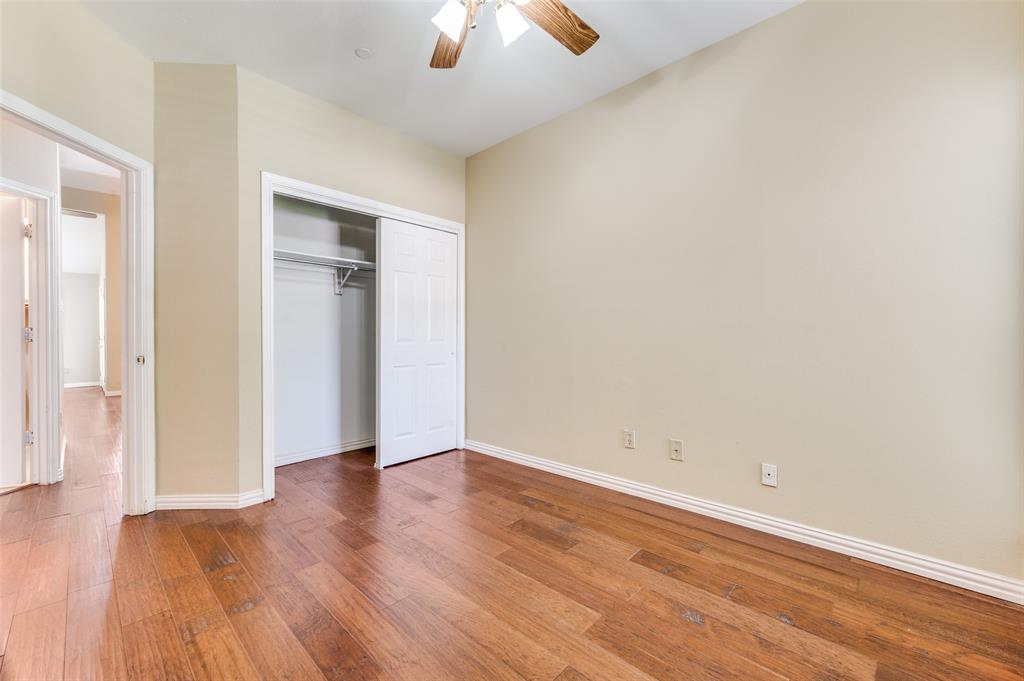 5565 Preston Oaks Road, Unit 130 Dallas, TX 75254 - Photo 17 of 25 Unfurnished bedroom featuring hardwood / wood-style floors, a ceiling fan, and a closet
