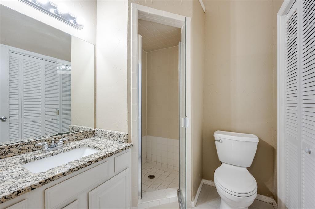 5565 Preston Oaks Road, Unit 130 Dallas, TX 75254 - Photo 21 of 25 Full bathroom featuring a closet, vanity, a stall shower, and light tile patterned floors