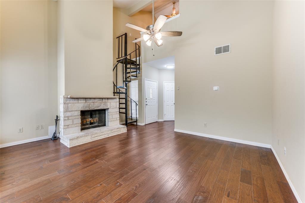 5565 Preston Oaks Road, Unit 130 Dallas, TX 75254 - Photo 5 of 25 Unfurnished living room featuring stairs, beam ceiling, dark wood-type flooring, a ceiling fan, and a towering ceiling