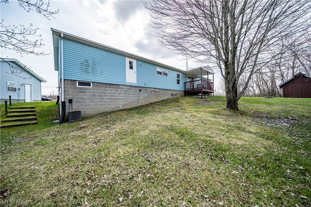 3471 Fox Road Kingsville, OH 44048 - Photo 4 of 50 Rear view of house featuring a yard and central AC