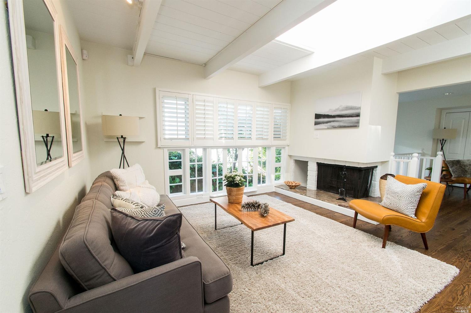 883 Marin Drive Mill Valley, CA 94941 - Photo 1 of 1 a living room with furniture and a fireplace