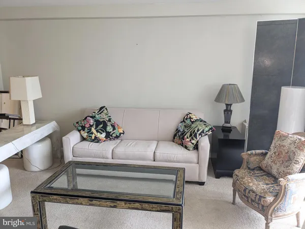 a living room with furniture and a lamp