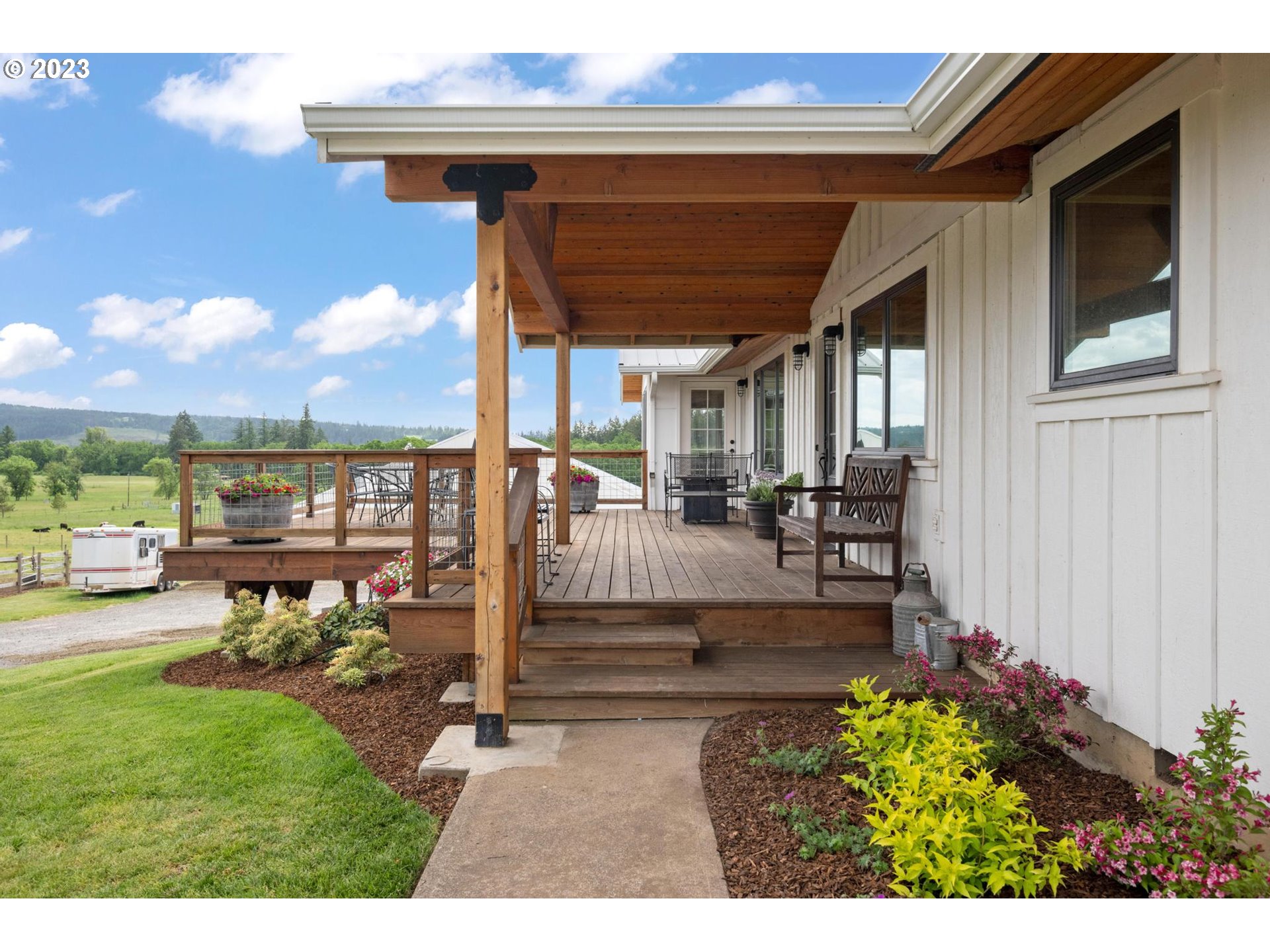 32877 South Wright Road Molalla, OR 97038 - Photo 3 of 34 a view of a porch with chairs and potted plants
