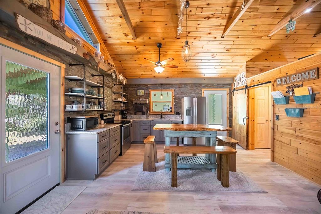 7348 Coach Road Port Charlotte, FL 33981 - Photo 13 of 48 a room with stainless steel appliances kitchen island granite countertop furniture and a rug