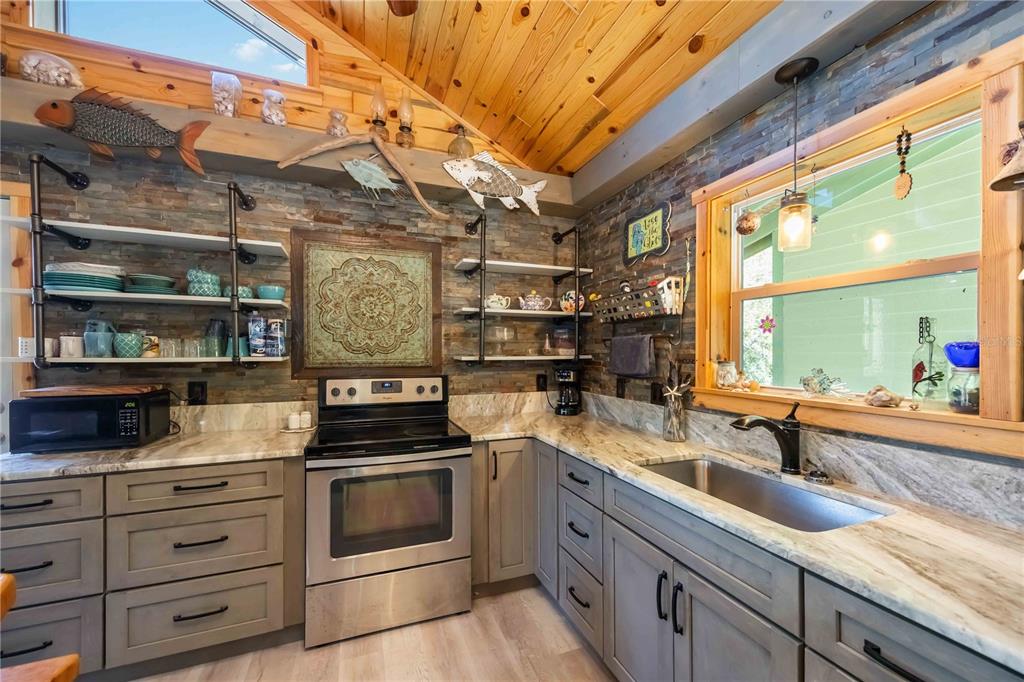 7348 Coach Road Port Charlotte, FL 33981 - Photo 16 of 48 a kitchen with stainless steel appliances granite countertop a stove and a sink