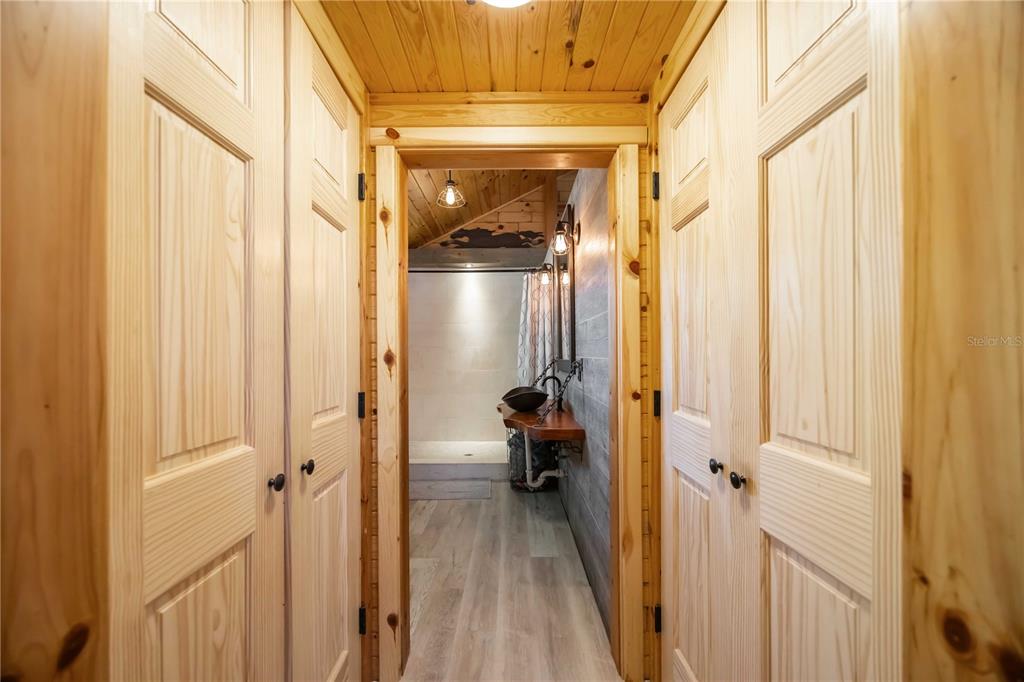 7348 Coach Road Port Charlotte, FL 33981 - Photo 19 of 48 a view of a hallway with wooden shelves