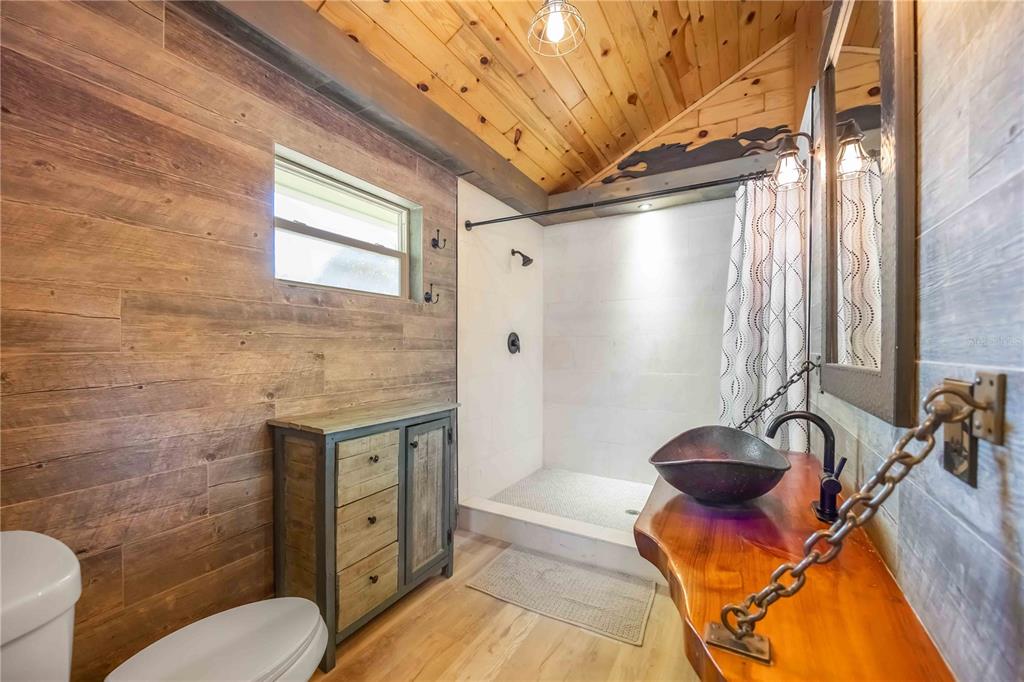 7348 Coach Road Port Charlotte, FL 33981 - Photo 20 of 48 a bathroom with a granite countertop sink a toilet and shower