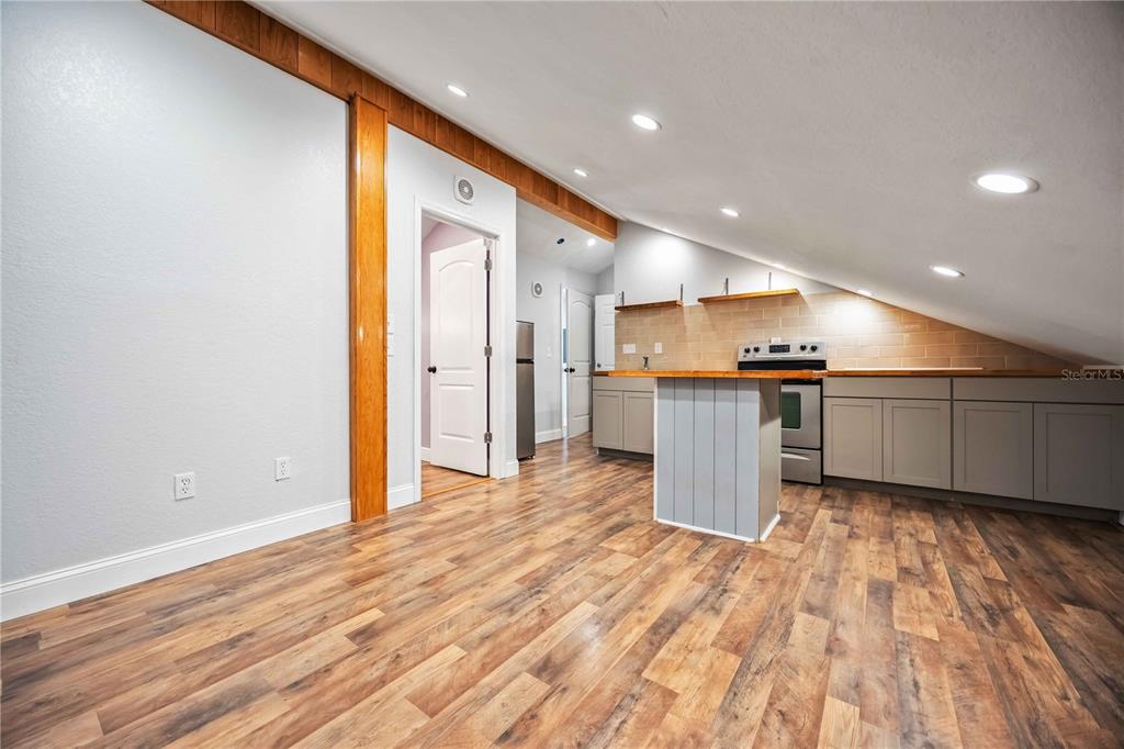 7348 Coach Road Port Charlotte, FL 33981 - Photo 24 of 48 a view of a big room with wooden floor and windows